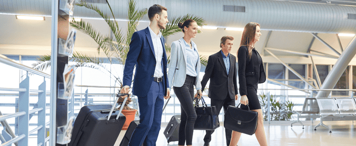 A group of professionals walk through an airport